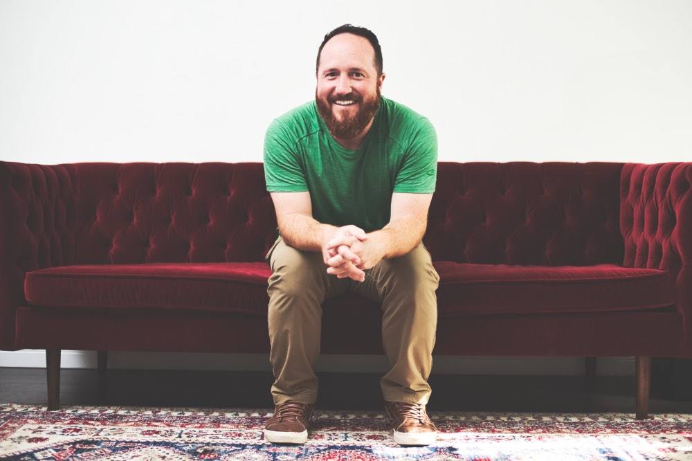 Bradley on a red couch at Open Door Church
